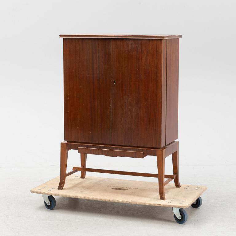 A mahogany veneered drinks cabinet, mid 20th Century.