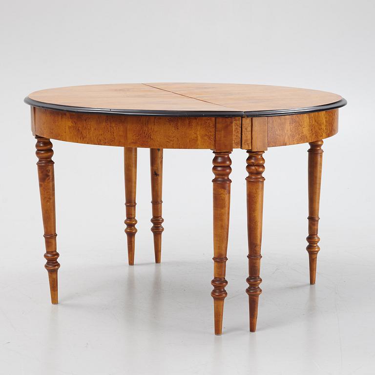 A birch veneered dining table, second half of the 19th Century.