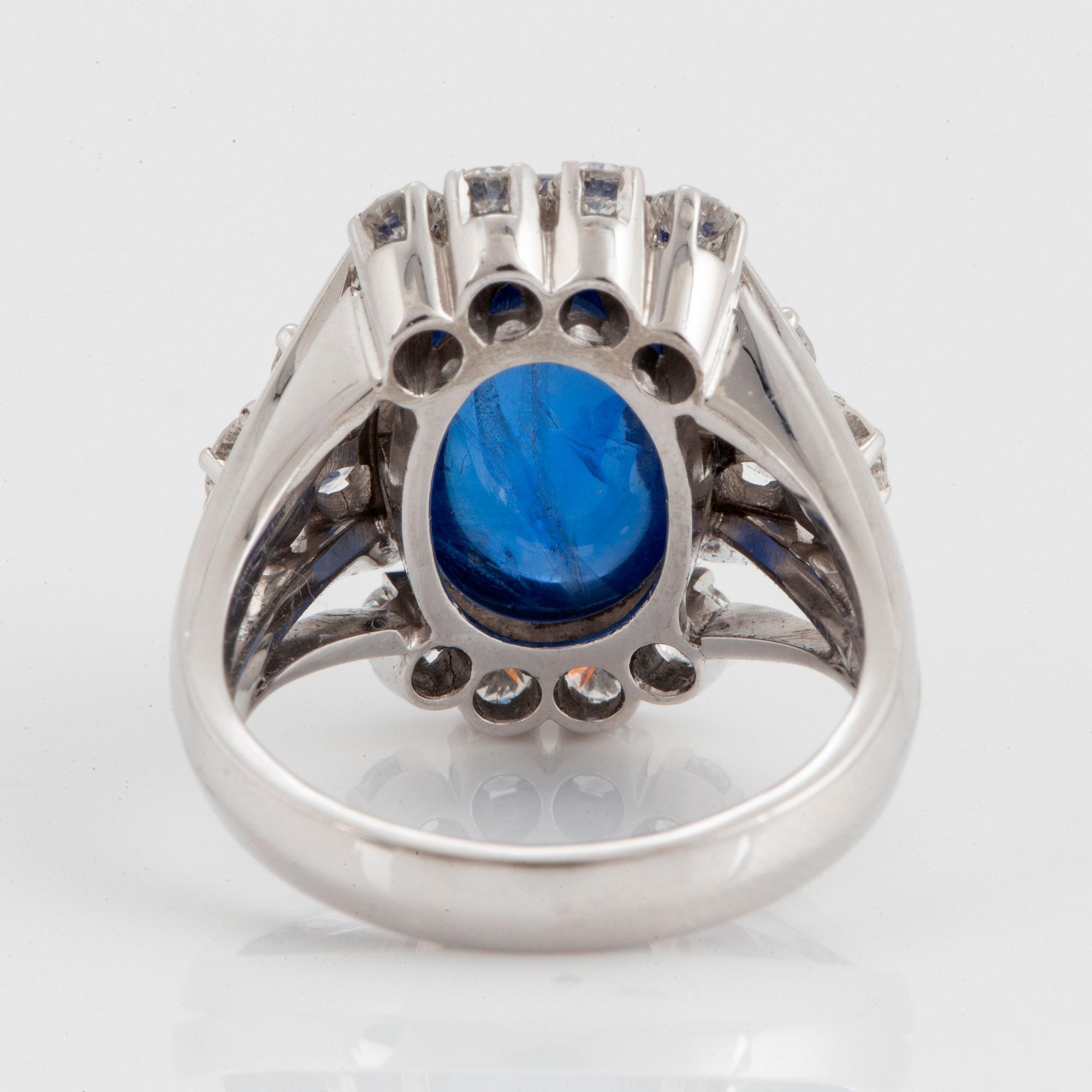 Ring 18K vitguld med en cabochonslipad safir ca 11.00 ct samt runda briljantslipade diamanter.