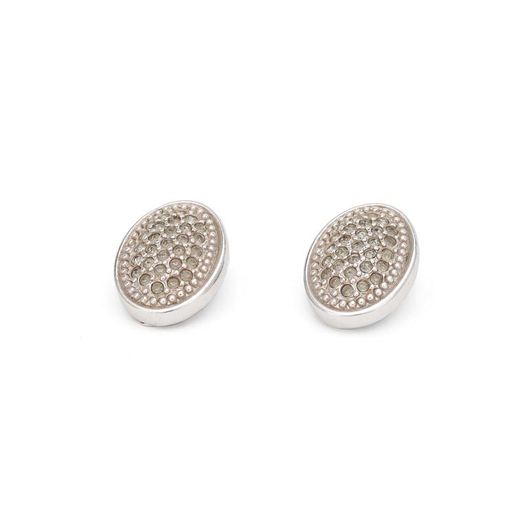 BURBERRY, a pair of silver colored clip earrings.