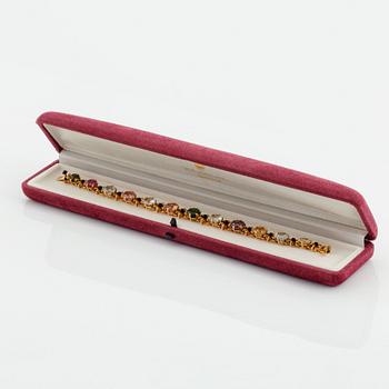 A WA Bolin bracelet in 18K gold set with coloured gemstones.