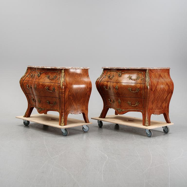A pair of rococo style chest of drawers, mid 20th Century.
