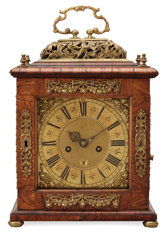 A Queen Anne early 18th century brass-mounted walnut striking table clock by Jacobeus Markwick.