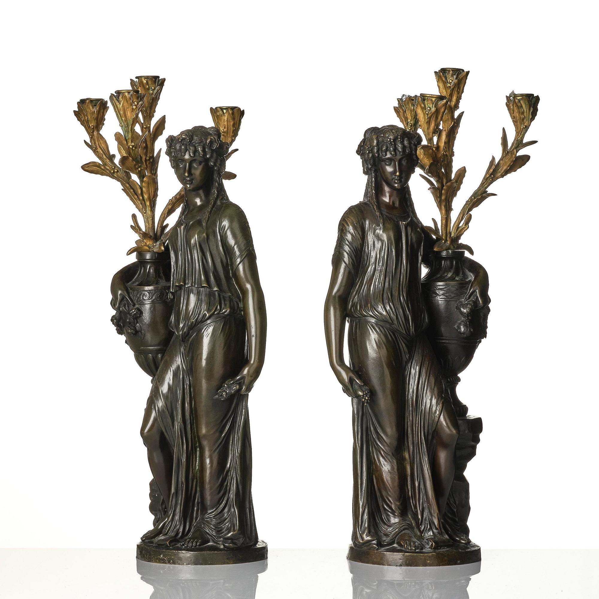 A pair of Louis XVI-style four-light gilt and patinated bronze candelabra after Clodion, later part 18th century.