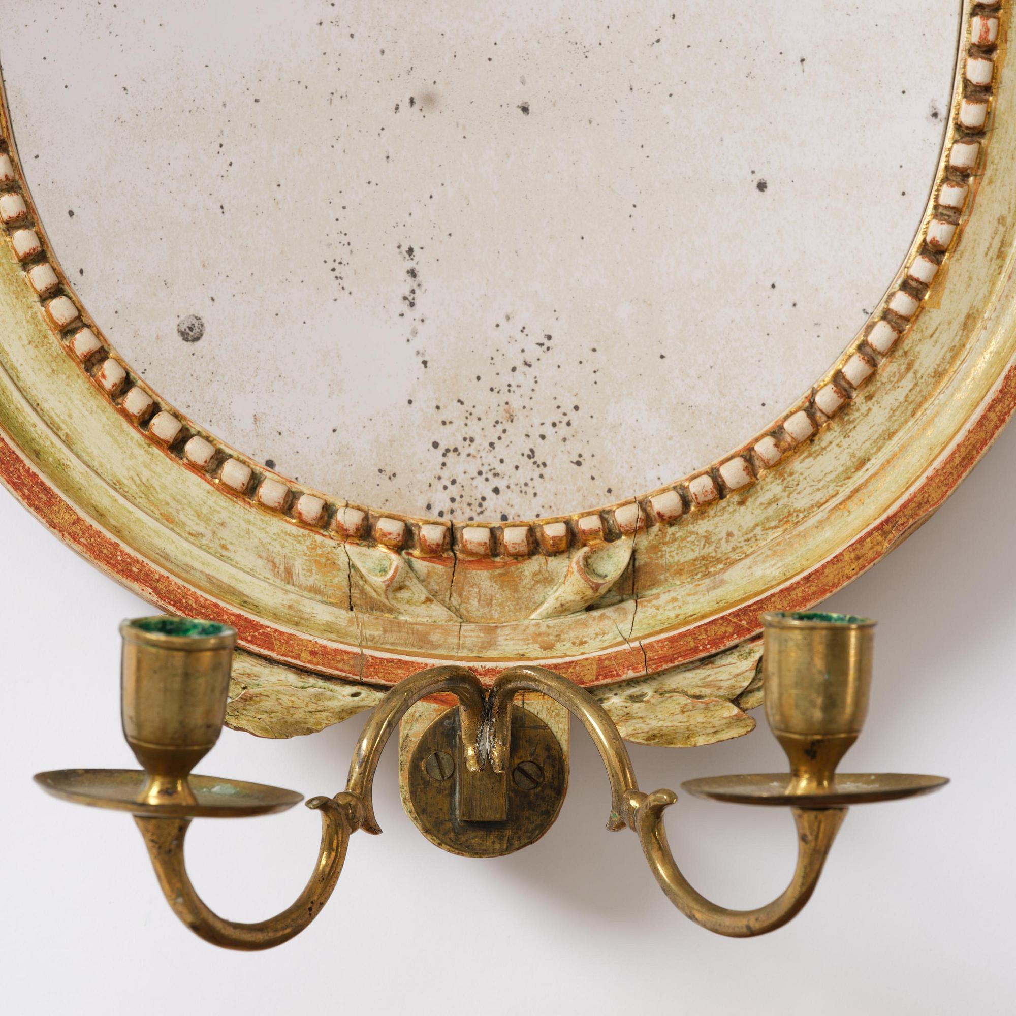 A pair of Gustaviantwo-branch giltwood girandole mirrors by C. G. Fyrwald (master in Stockholm 1776-1825).