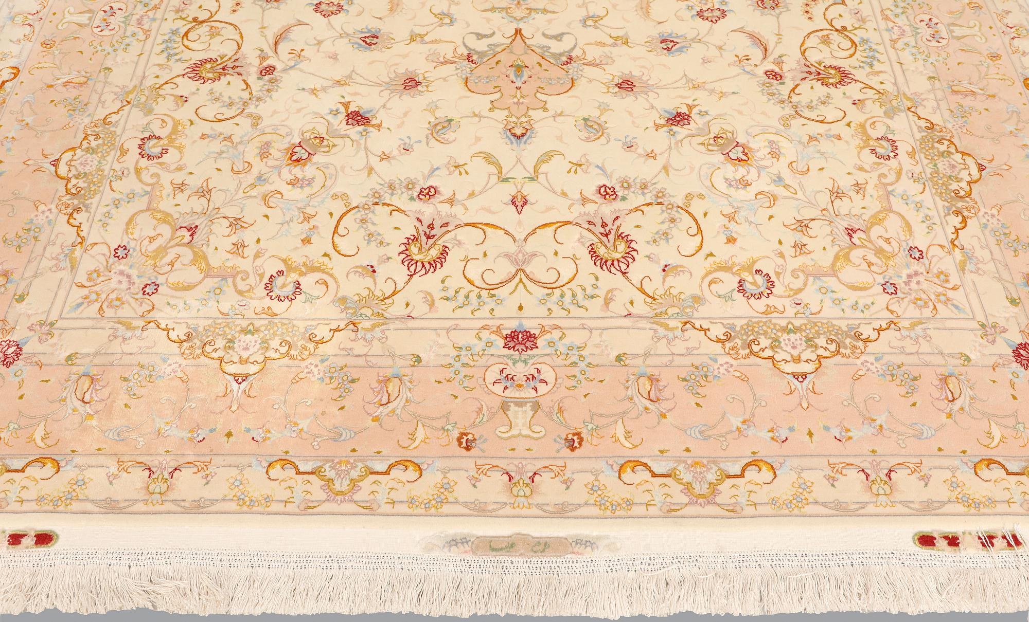 A Tabriz part silk carpet, signed, 305 x 203 cm.