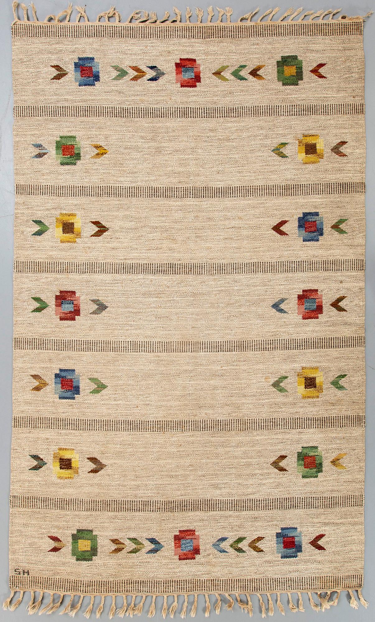A Swedish flat weave carpet signed SH ca 243 x 162 cm.