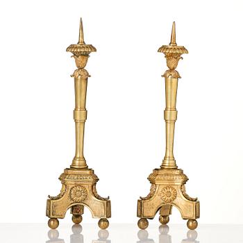 A pair of presumably Italian Empire ormolu candlesticks, early 19th century.