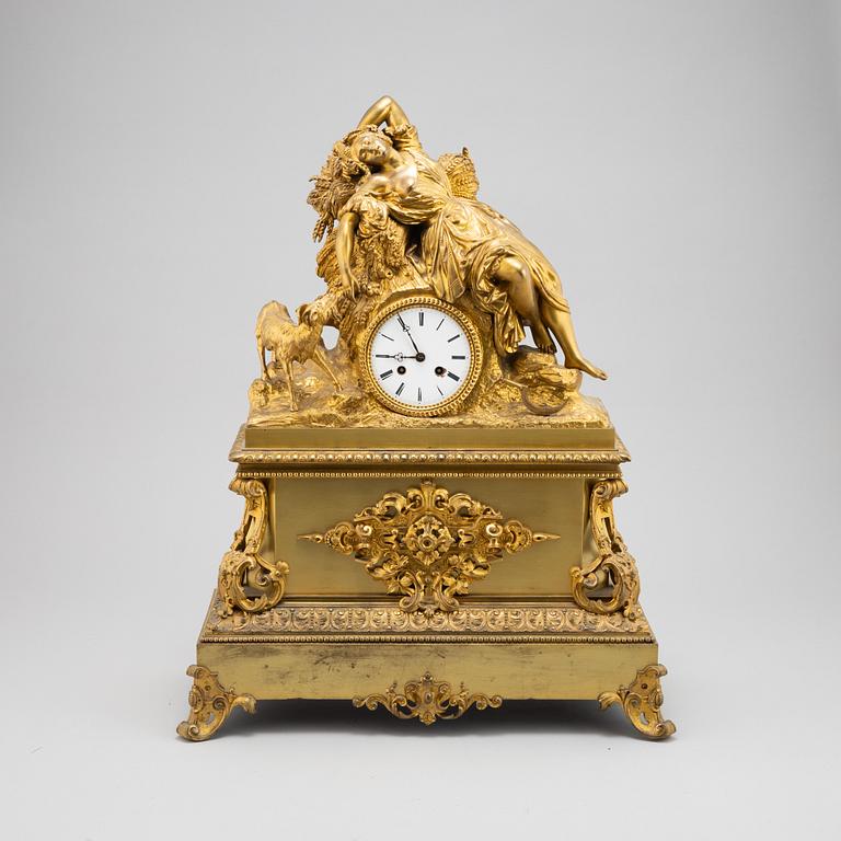 A mid 19th Century brass and gilt brass mantel clock.
