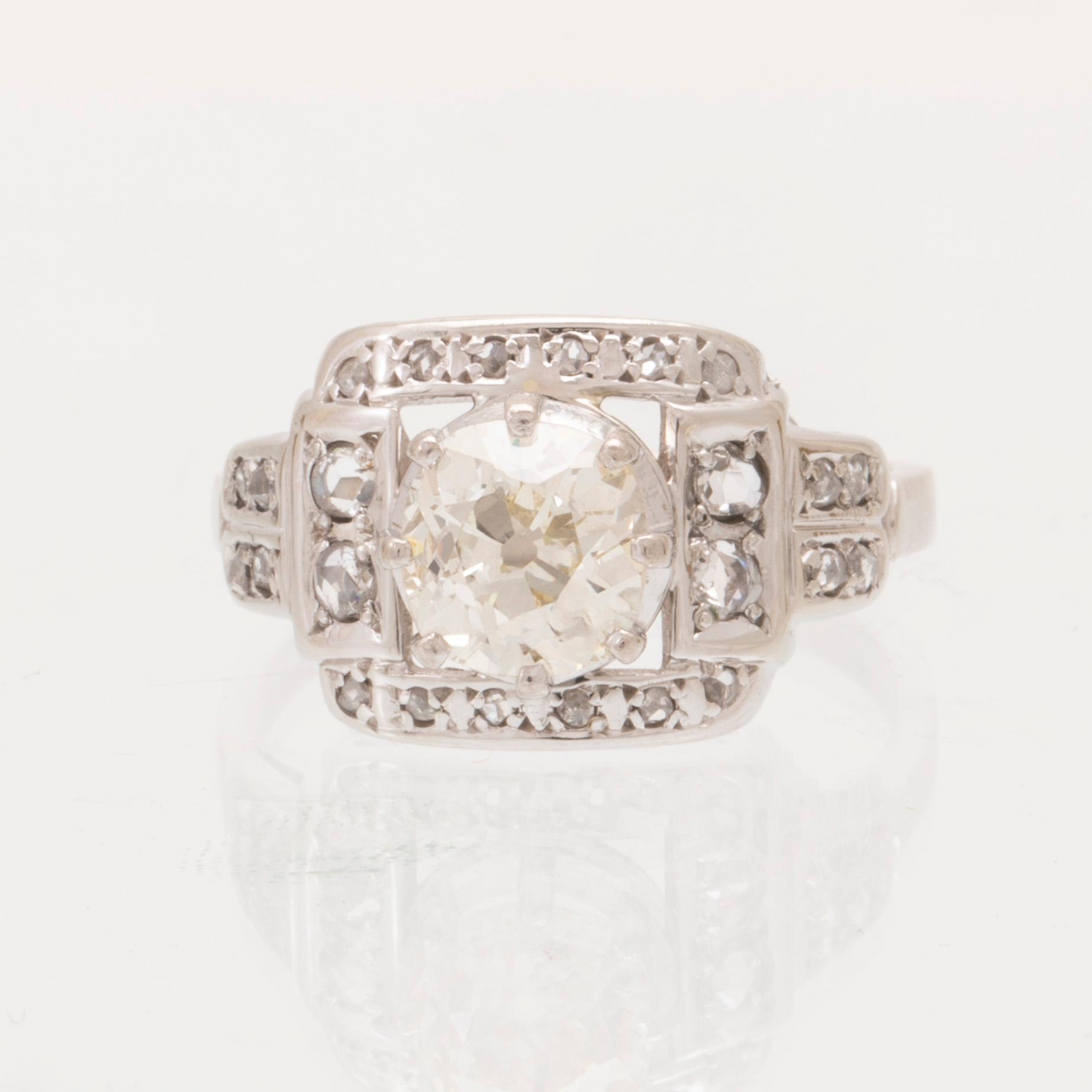 An 18K white gold ring set with an old cut diamond and rose cut diamonds.