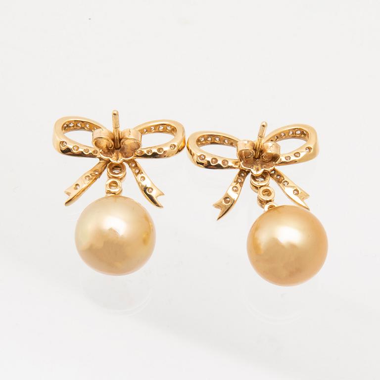 A pair of 18K gold earrings set with round brilliant-cut diamonds and cultured pearls.