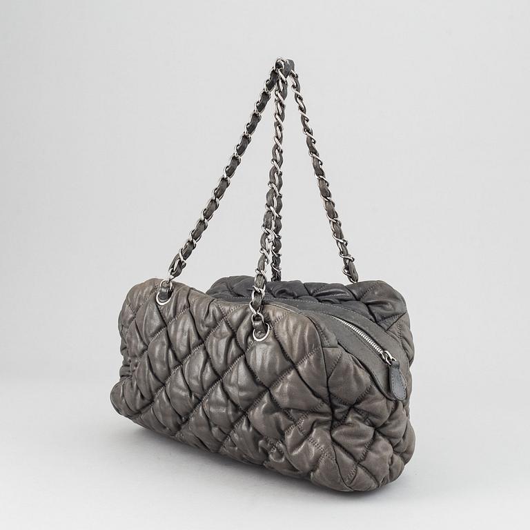 Chanel, a grey leather bag.