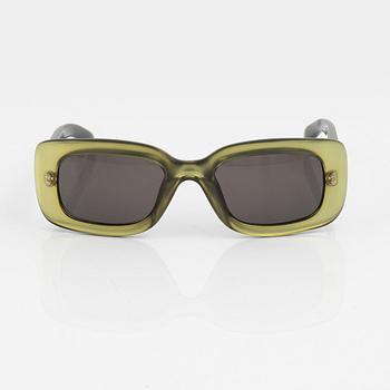Gucci, a pair of green sunglasses.