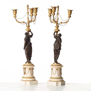 A pair of Louis XVI 18th century gilt and patinated bronze and marble three-light candelabra.