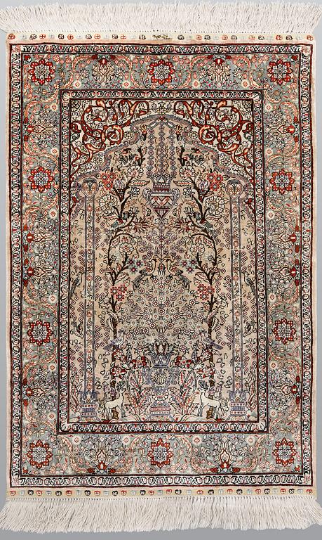 An oriental silk rug, approx. 95 x 63 cm.