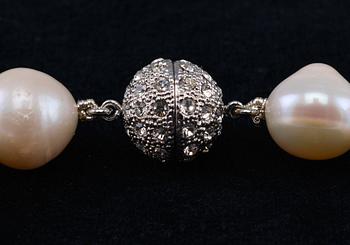 A NECKLACE, cultivated fresh water pearls 11 - 12 mm. Clasp in rhodium plated metal. Length 44 cm.