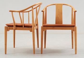 A pair of Hans J Wegner cherry and brown leather 'China chairs', Fritz Hansen, Denmark 1988.