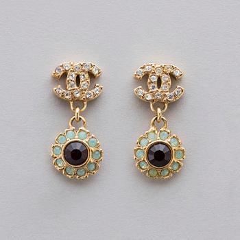 Apair of Chanel golden earrings with white and red stones, 2006.