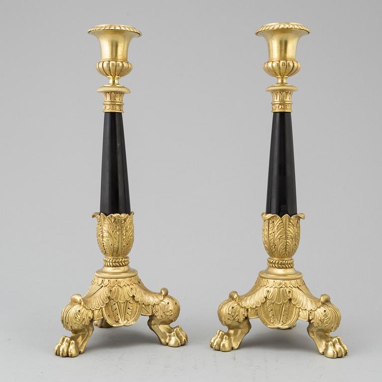 A pair of Empire style candlesticks, 20th Century.