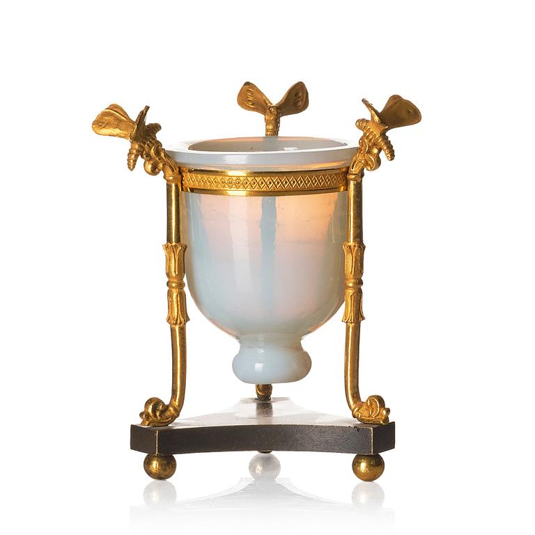 An Empire tripod with an opalin glass bowl, first part of the 19th century.