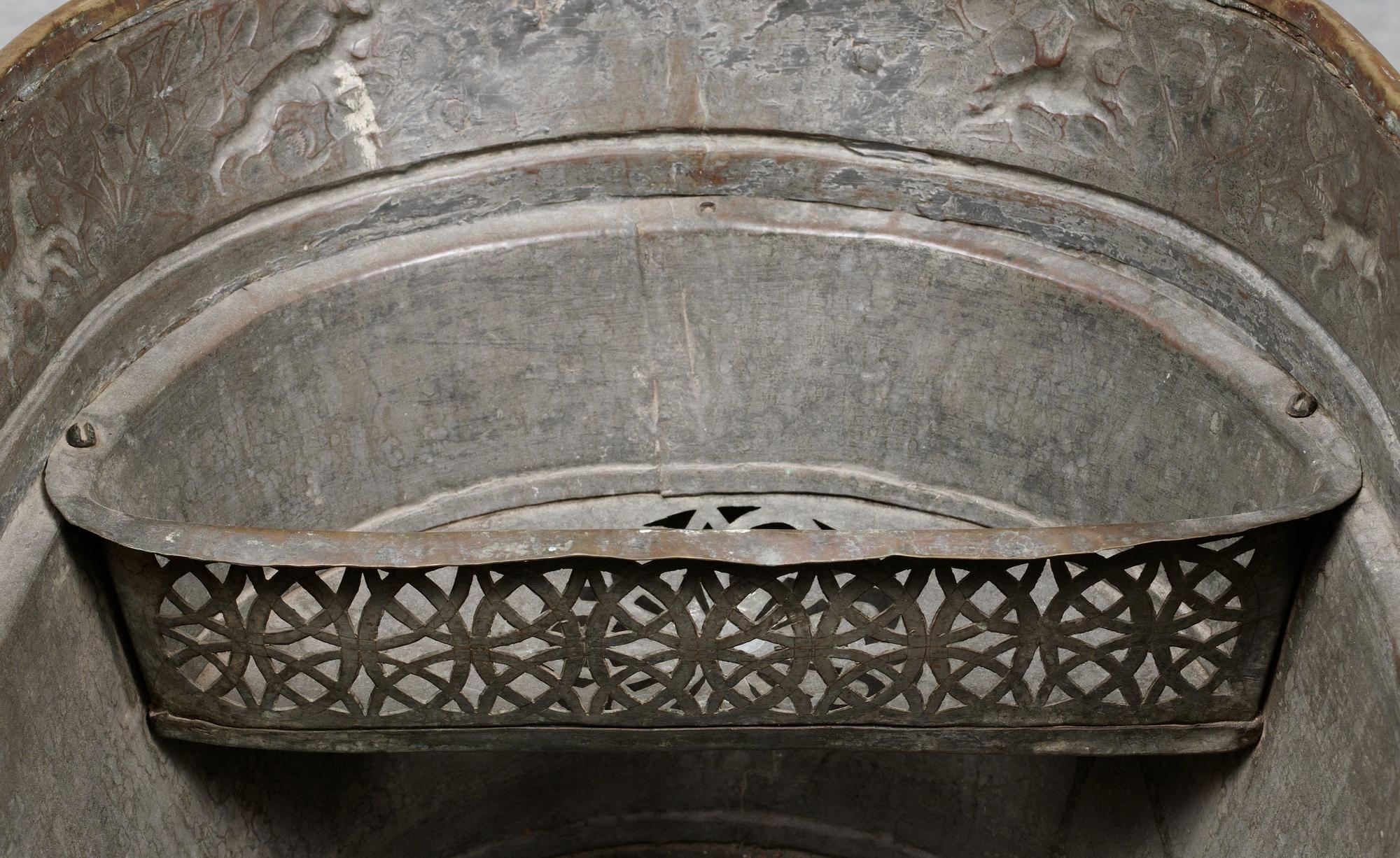 A Baroque brass wine cooler.