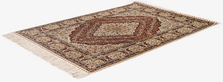 A semi-antique silk Hereke rug, West Anatolia, c. 180 x 121 cm.