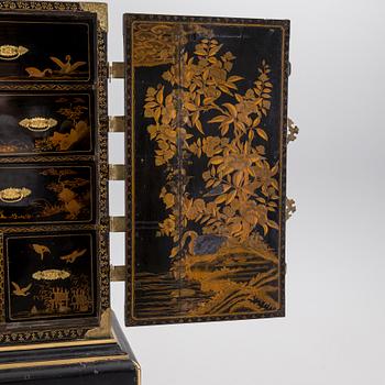 AN early 18TH CENTURY PROBABLY ENGLISH Japanned laquer cabinet on stand.