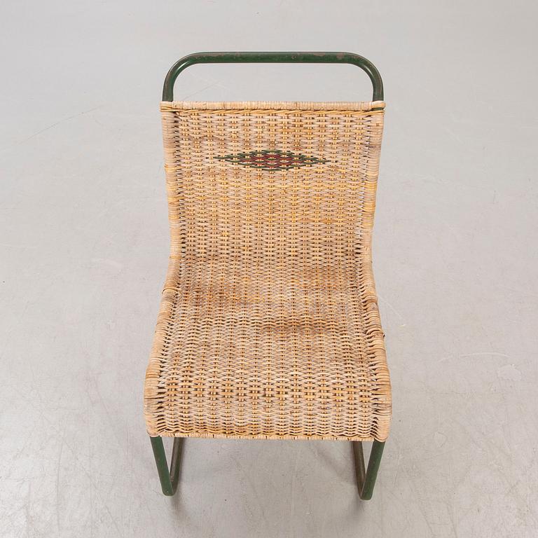 A 1930s braided rattan and metal chair.