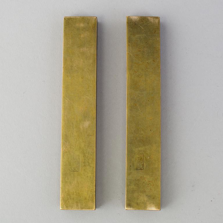 A pair of Japanese scroll weights, early 20th Century.