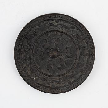 A lion and grapewine bronze mirror, Tang dynasty (618-907).