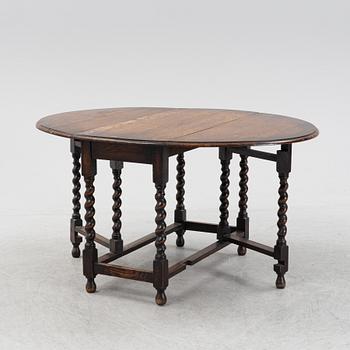 An oak baroque style gate leg table, 20th Century.
