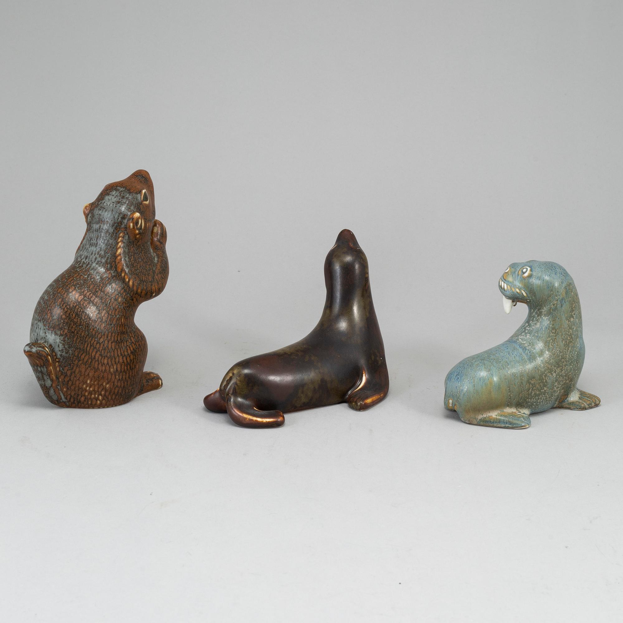 GUNNAR NYLUND, a set of thre stoneware sculptures; a squirrel, a walrus and a seal, Rörstrand, Sweden.