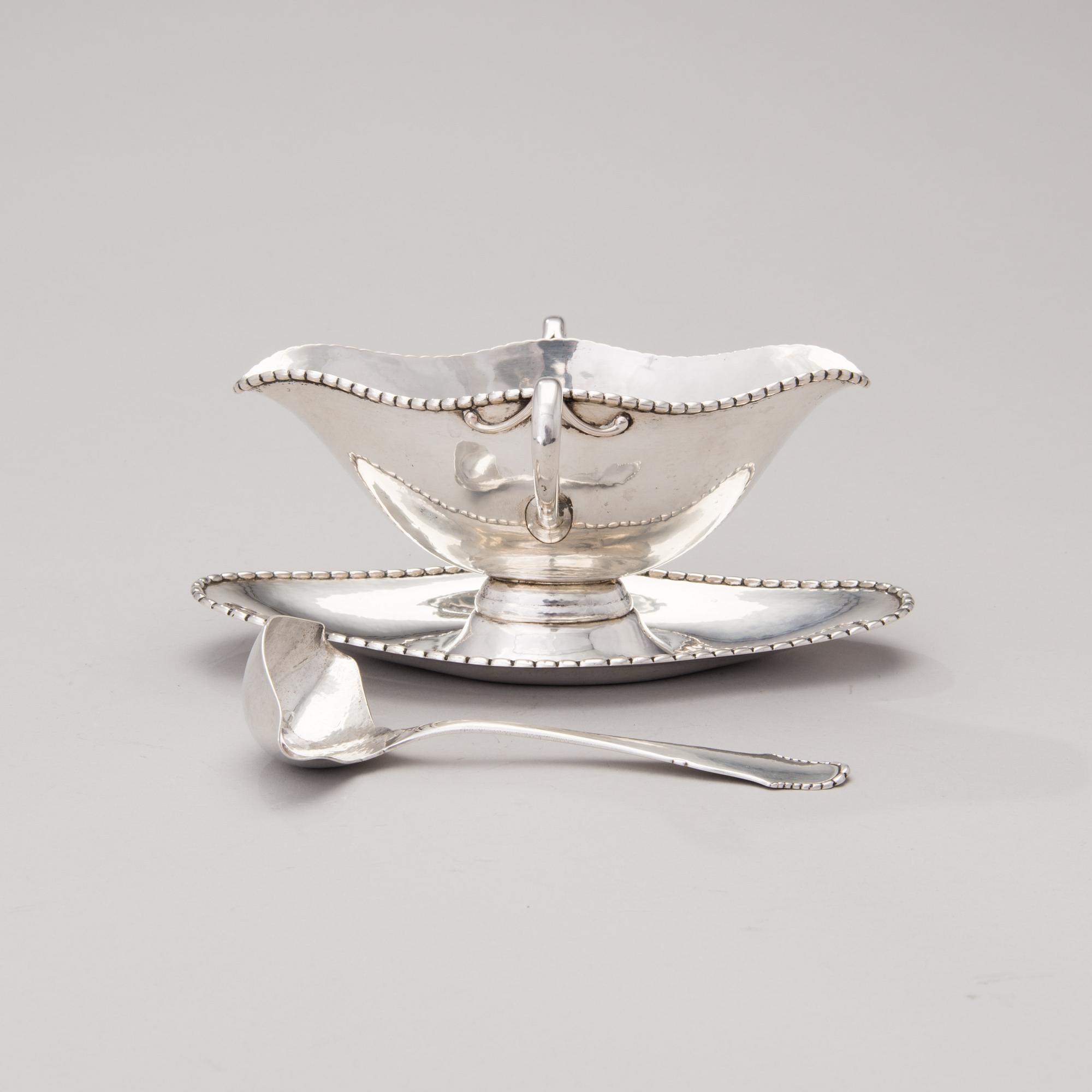 A sauce boat with a sauce ladle in silver, mark of Paul Bang, Copenhagen, Denmark 1929 and 1930s.