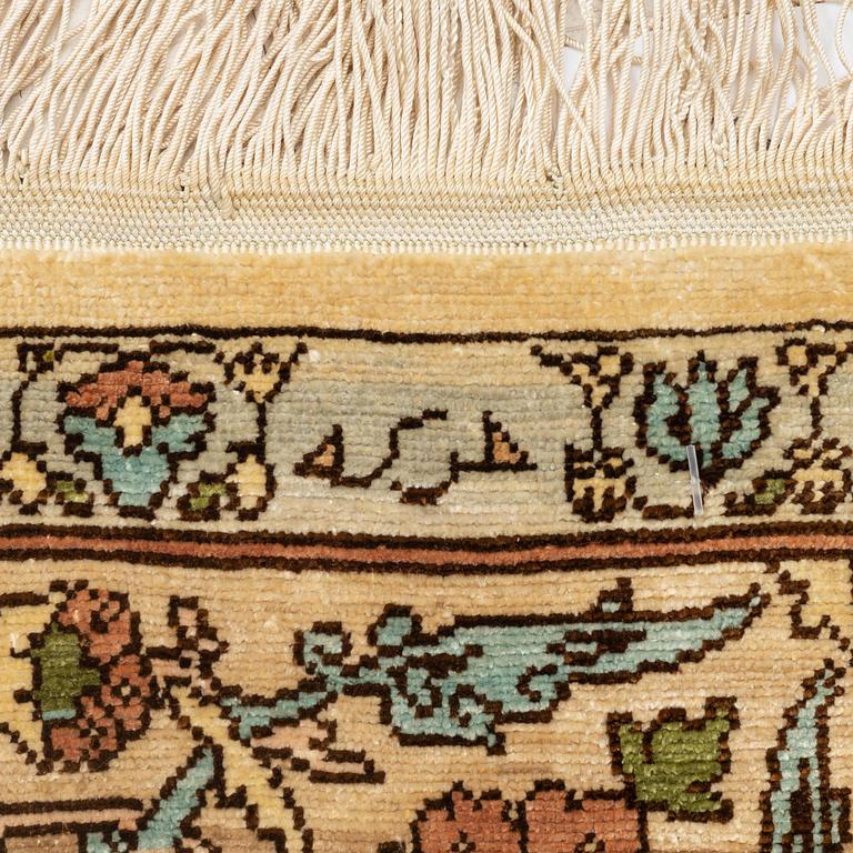A silk Hereke rug, c. 112 x 74 cm.
