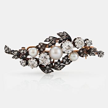 1145A. A silver and 14K gold brooch set with old- and rose-cut diamonds and pearls.