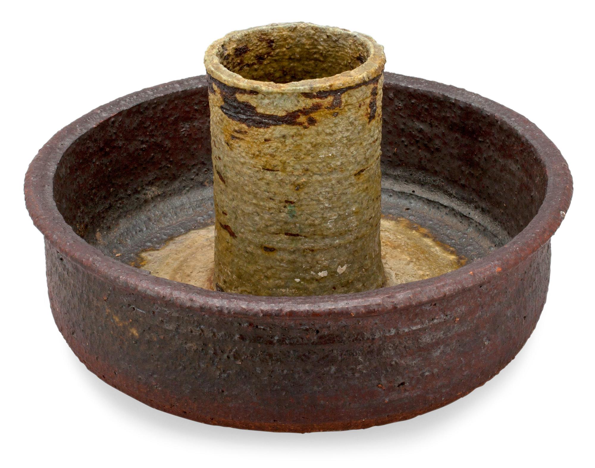 A CERAMIC CANDLESTICK.