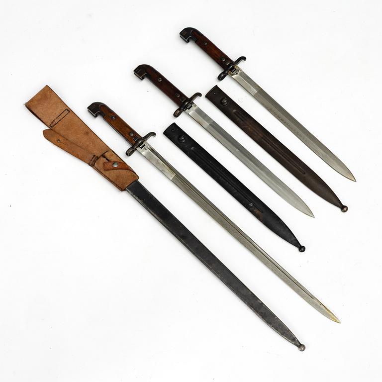 Three Swedish bayonets with scabbards.