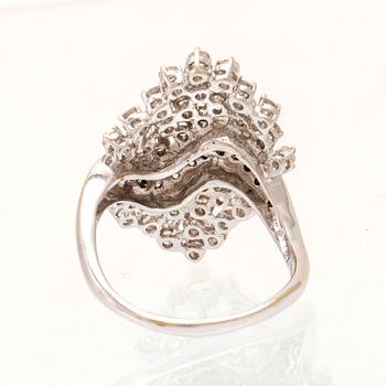An 18K white gold ring set with round brilliant cut diamonds.