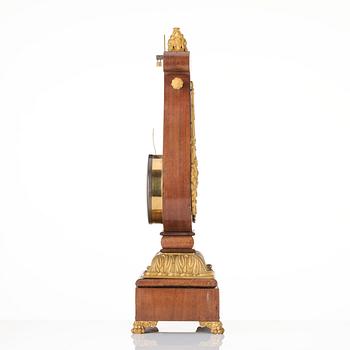 A French Empire mahogany, ormolu and gilt metal lyre-shaped mantel clock, early 19th century.