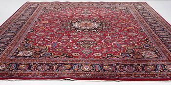 An Oriental carpet, approx. 380 x 304 cm.