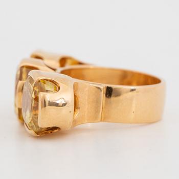 18K gold and yellow sapphire three-stone ring.