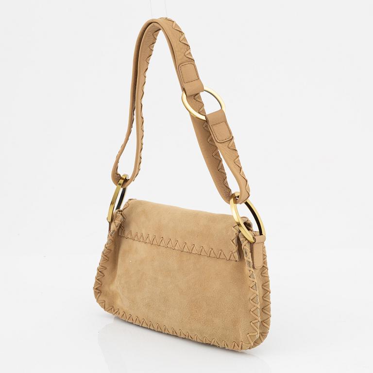Gucci, a suede handbag.