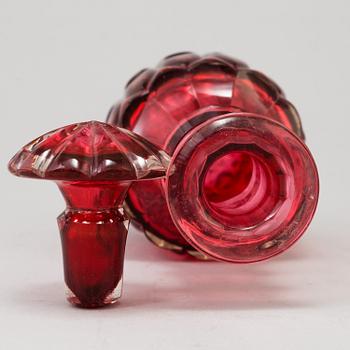 A MID 19TH CENTURY RED GLASS DECANTER AND STOPPER.