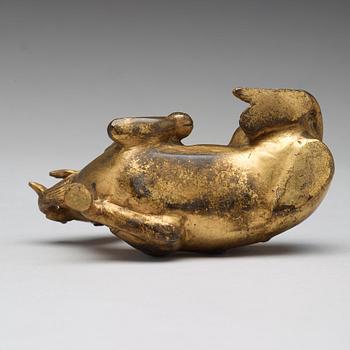 A gilt bronze figure of a reclining mythical animal, Qing dynasty, 19th Century.