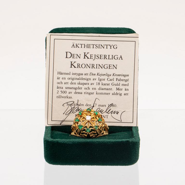 An 18K gold ring set with a round brilliant cut diamond and round single cut emeralds by Franklin Mint 1980.