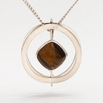 Elis Kauppi, A silver necklace/brooch with a tiger's eye. Kupittaan kulta, turku 1961.