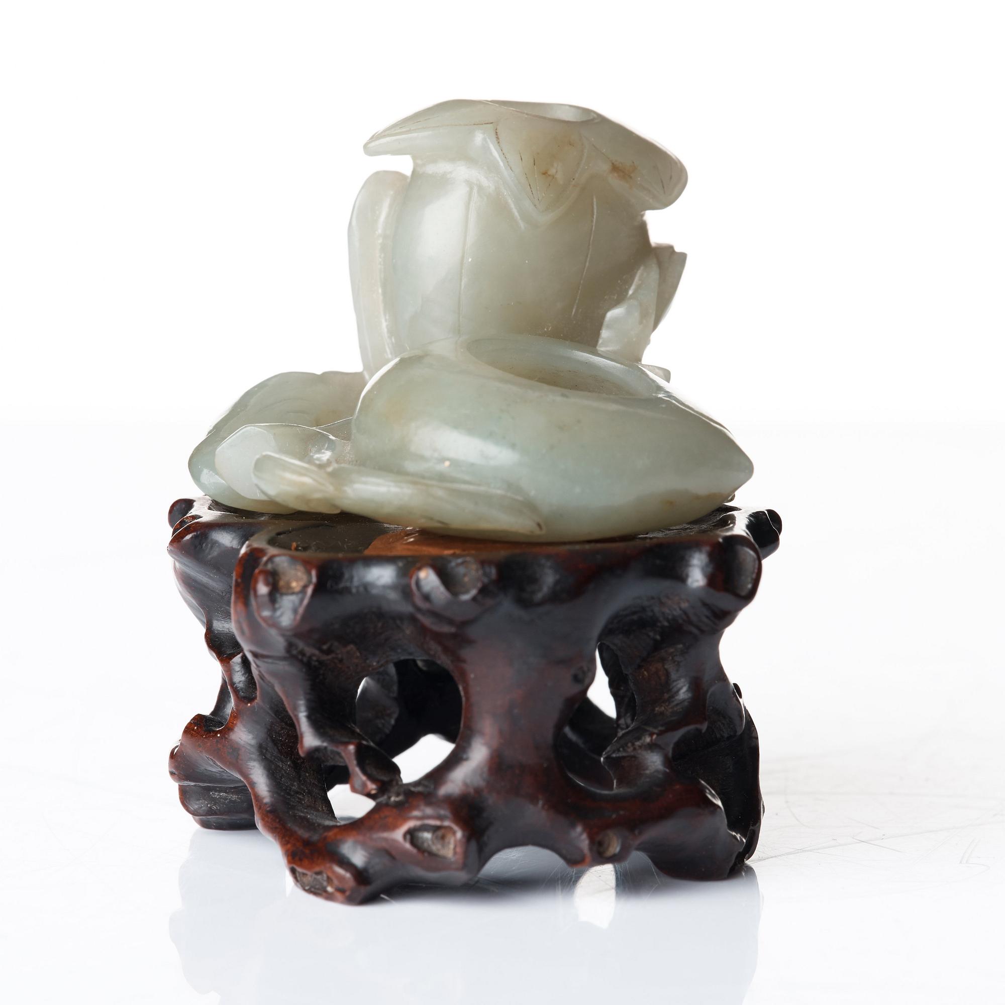 A sculptured nephrite belt buckle, figurine and brush washer, late Qing dynasty.