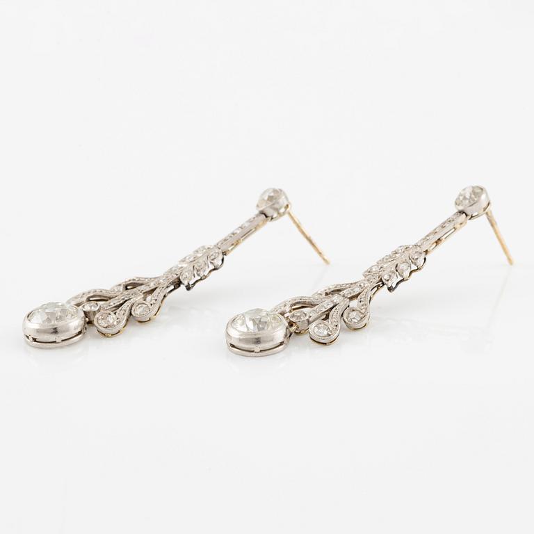 A pair of earrings in platinum and 18K gold set with old- and rose-cut diamonds.