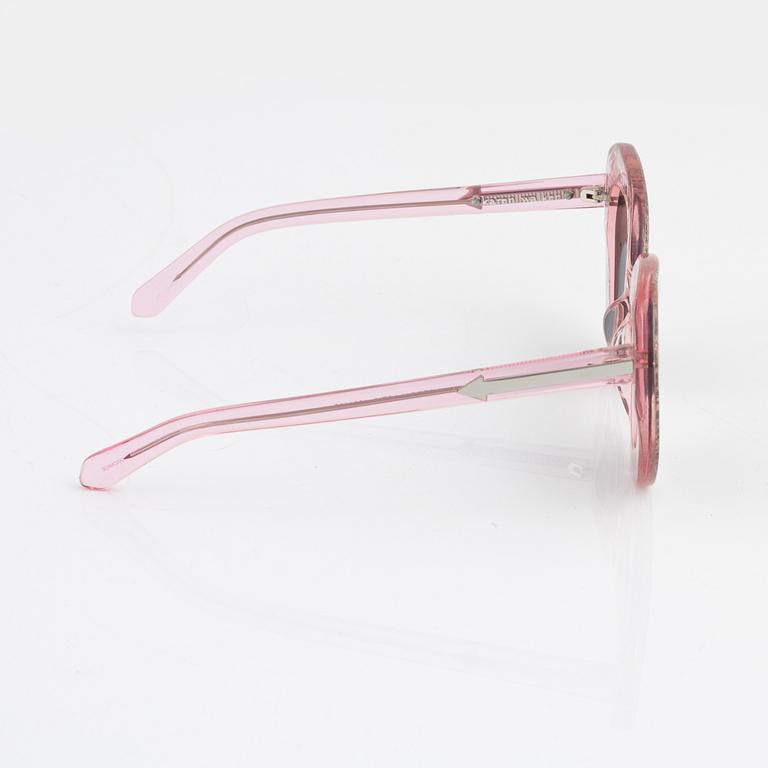 Karen Walker, a pair of pink "Intergalactic" sunglasses.