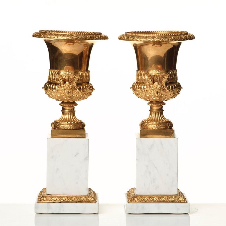 A pair of French 19th century gilded urns.